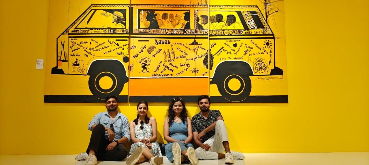 Friends in front of a yellow van mural in Azerbaijan