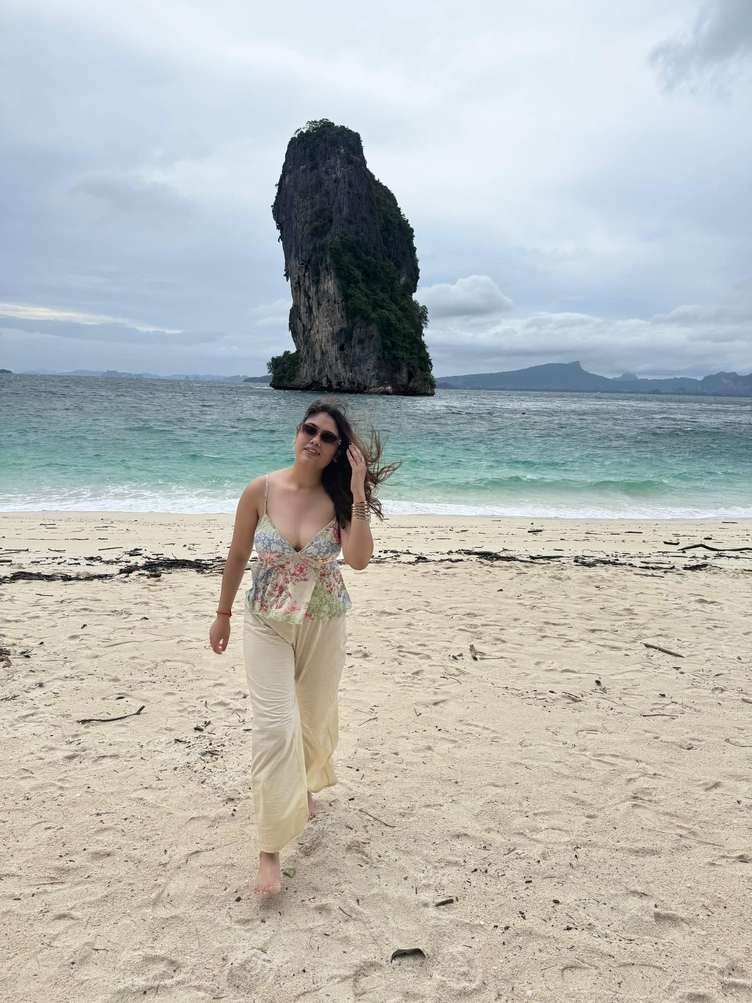 On the beach below a limestone sea stack, Thailand