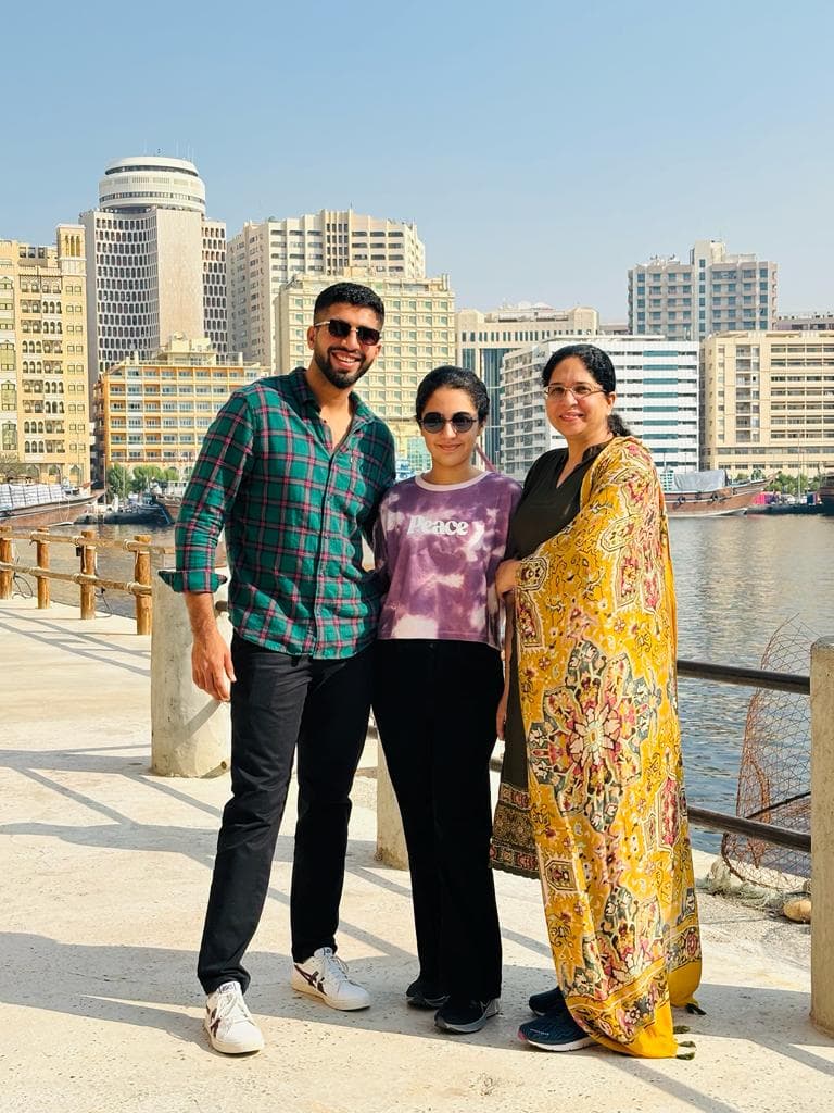 Grown-up children with their mum on a waterfront promenade